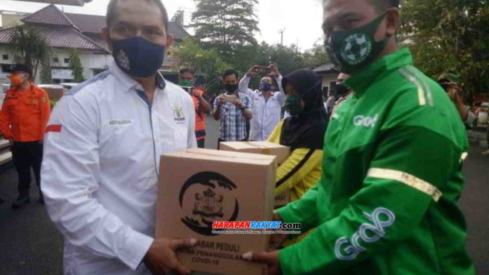 Ketua Kadin Kota Banjar saat memberikan bantuan paket sembako. Foto: Muhlisin/HR.